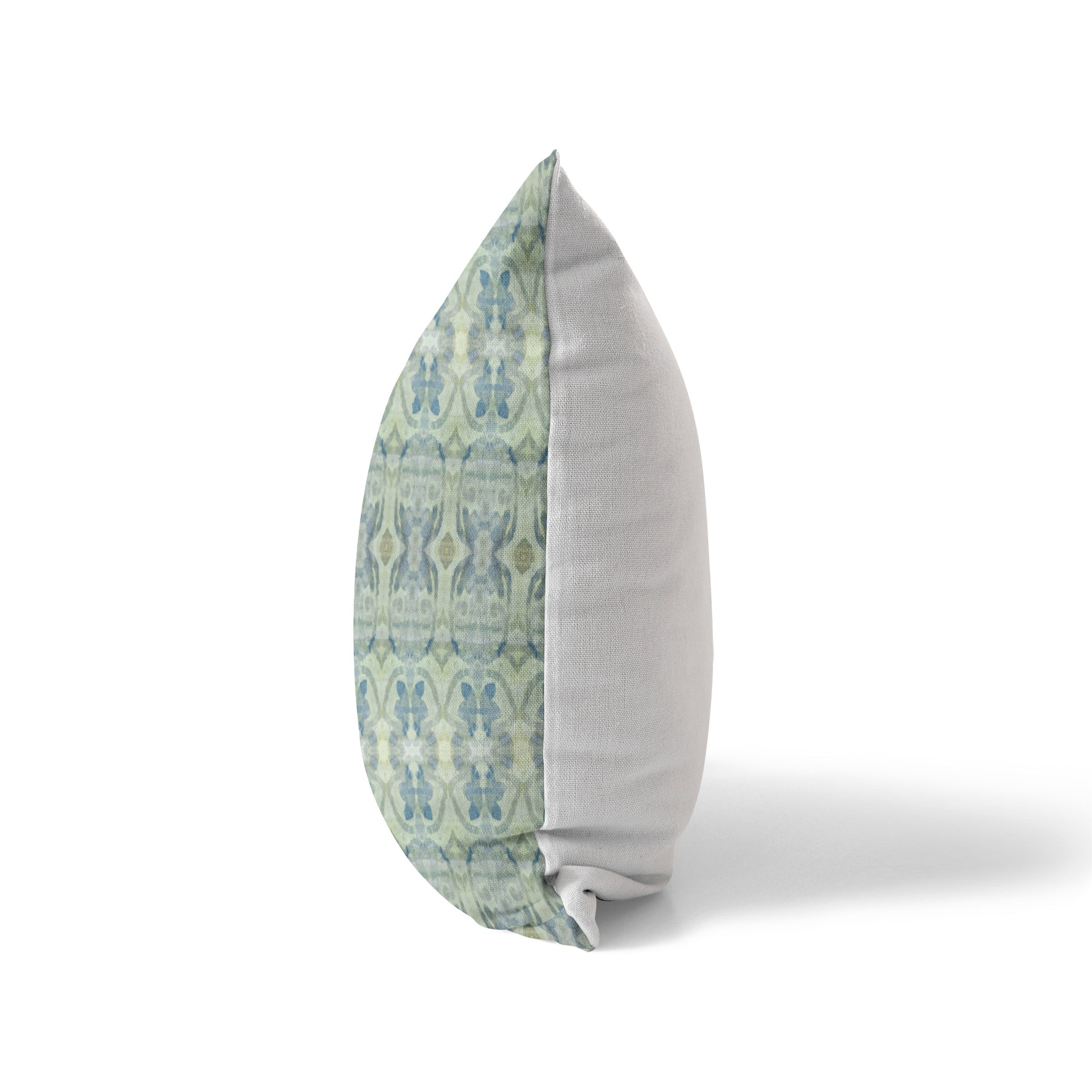 Side view of a pillow featuring an abstract blue and green pattern and solid white back