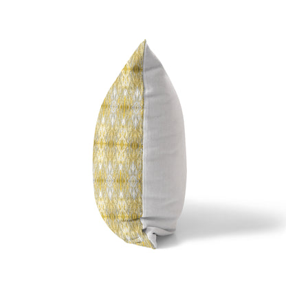 Side view of a pillow featuring a yellow abstract pattern and solid white back