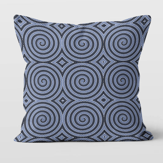 Pillow featuring geometric circular pattern in blue and white.