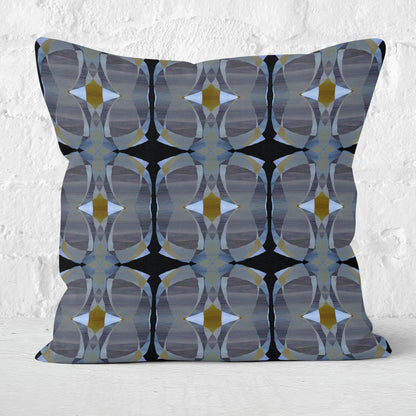 Square throw pillow featuring a gray and black abstract pattern and a white brick wall in the background