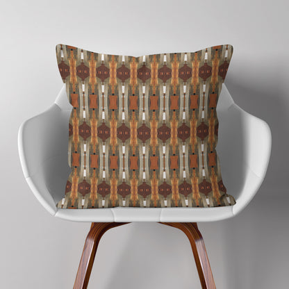 Throw pillow featuring collage pattern in wood and warm tones, sitting on a white chair