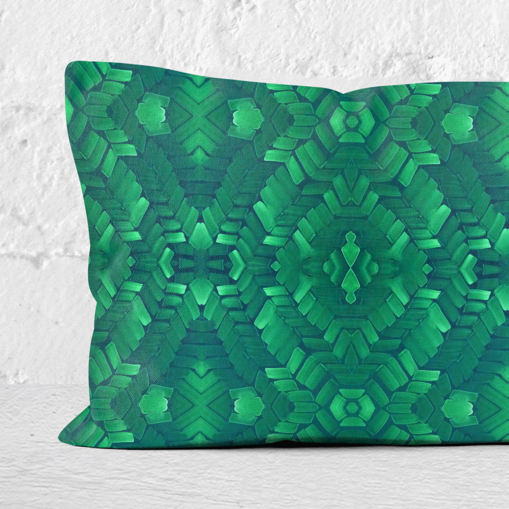 Detail of a rectangular lumbar pillow featuring a hand-painted abstract pattern in bright green.