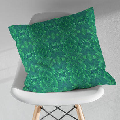 Square pillow featuring an abstract green pattern, sitting on a white modernist chair