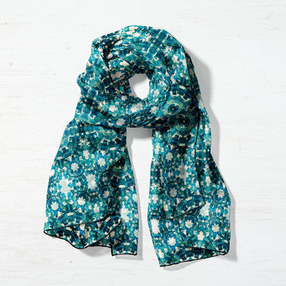 Silk habitat scarf featuring a teal abstract watercolor pattern, wrapped in a circular form