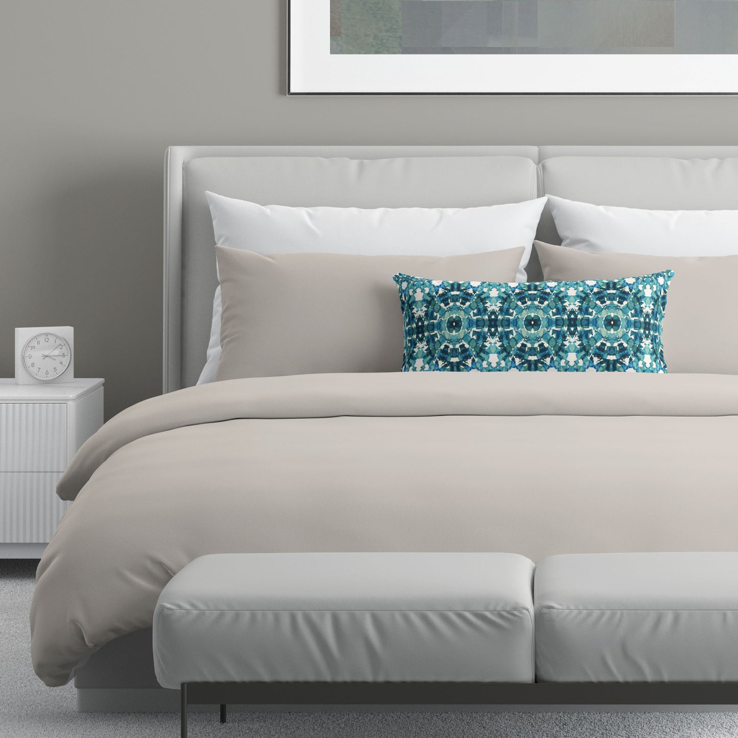 Neutral colored bedroom featuring a bed with an teal abstract patterned lumbar pillow.