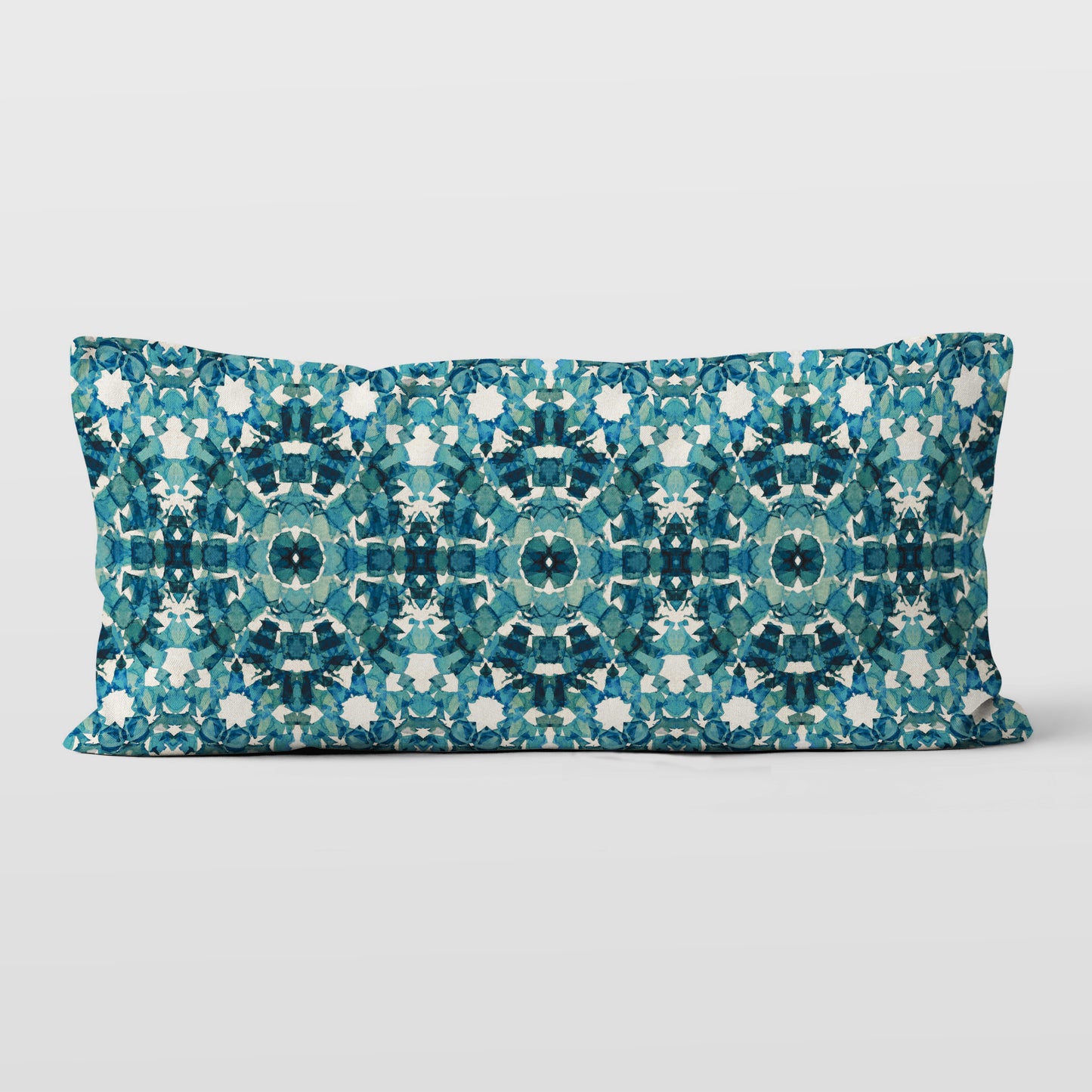 Rectangular lumbar pillow featuring handprinted pattern in teal 