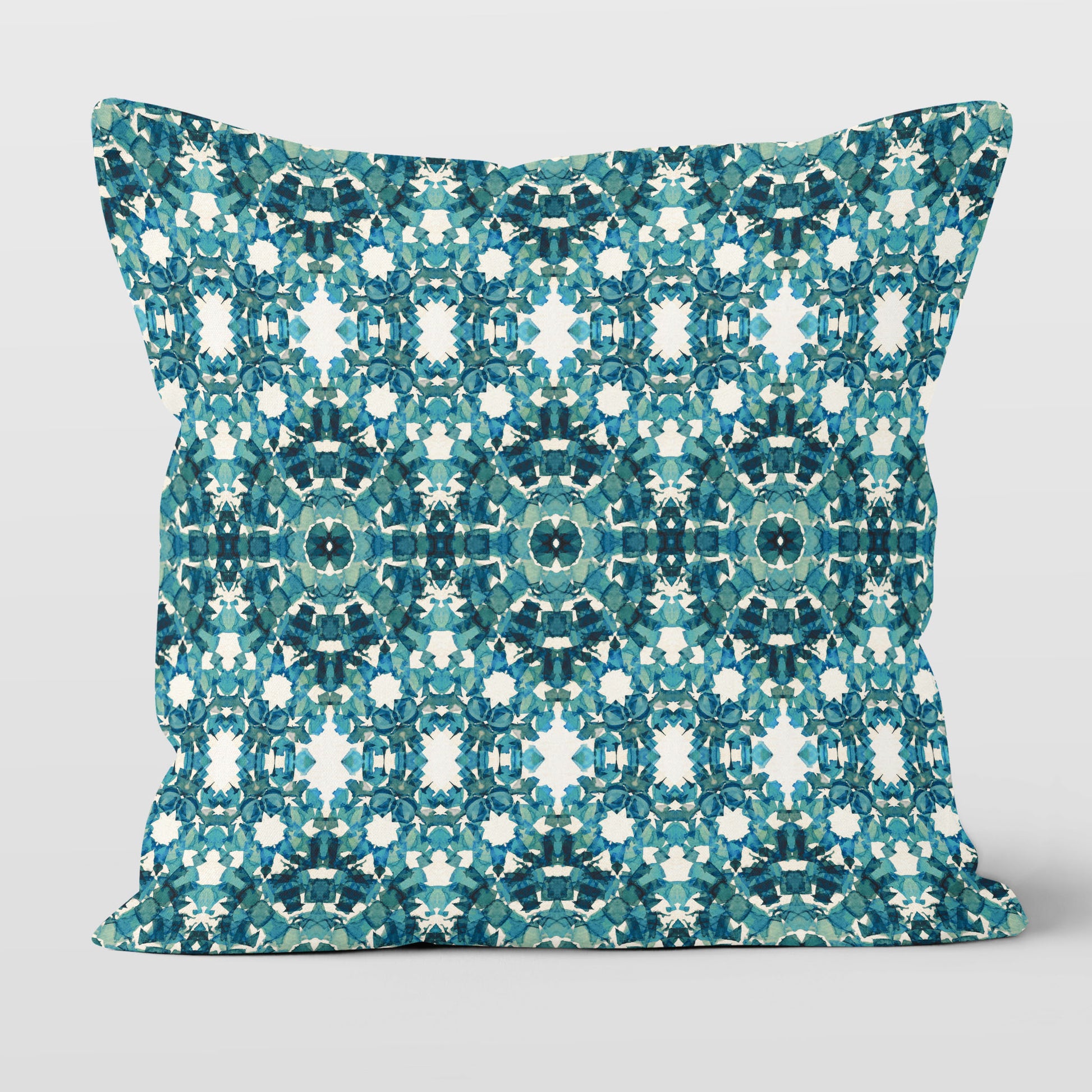 Square throw pillow featuring an abstract teal pattern