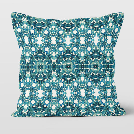 Square throw pillow featuring an abstract teal pattern