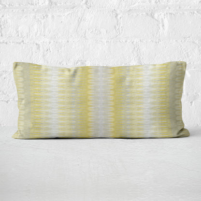 Striped pillow with yellow and gray pattern on a white background