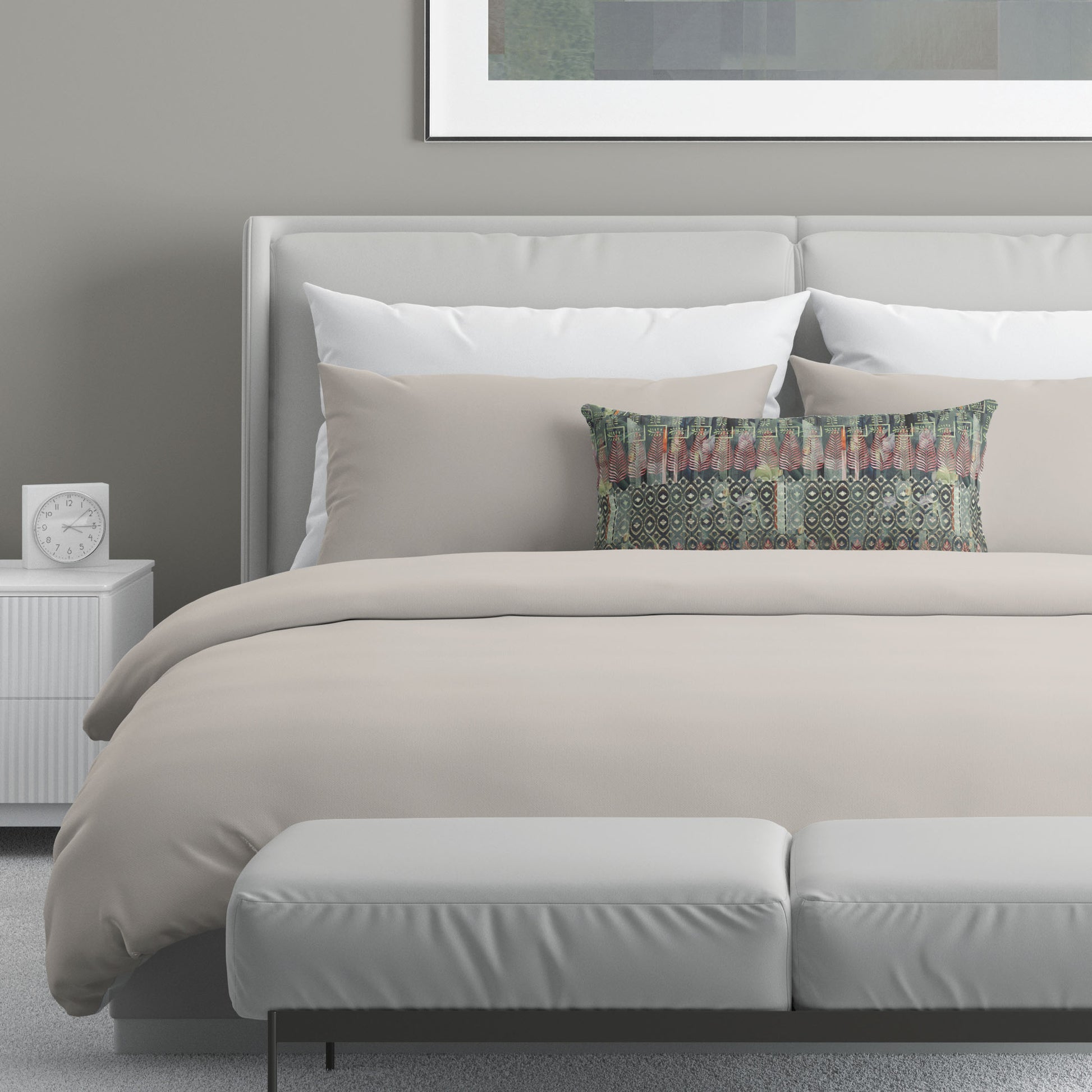 Neutral colored bedroom featuring a bed with a green and red abstract patterned lumbar pillow.