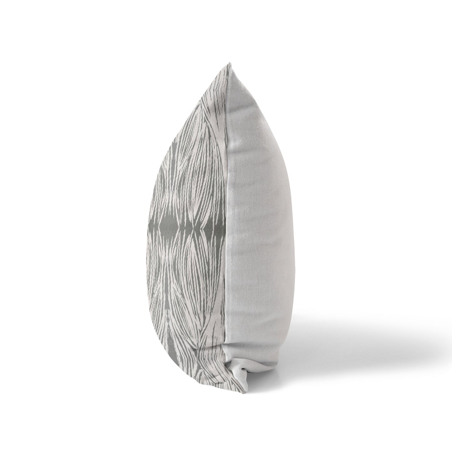 Side view of a pillow featuring a gray and beige abstract pattern and solid white back