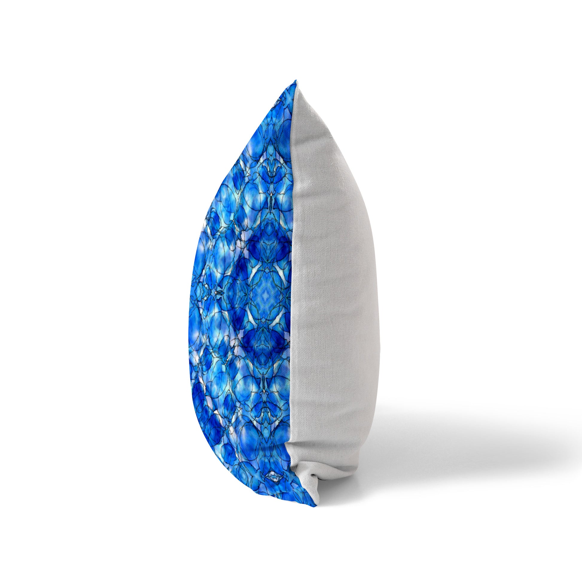 Side view of a pillow featuring an abstract cobalt blue pattern and solid white back