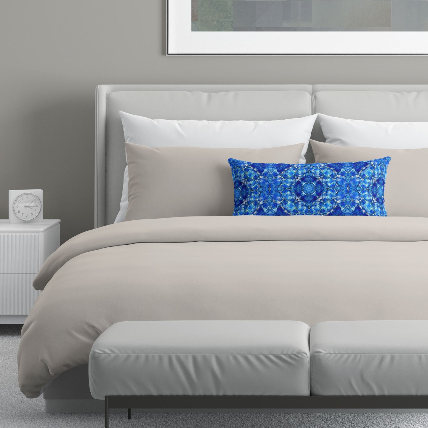 Neutral colored bedroom featuring a bed with a blue abstract patterned lumbar pillow.