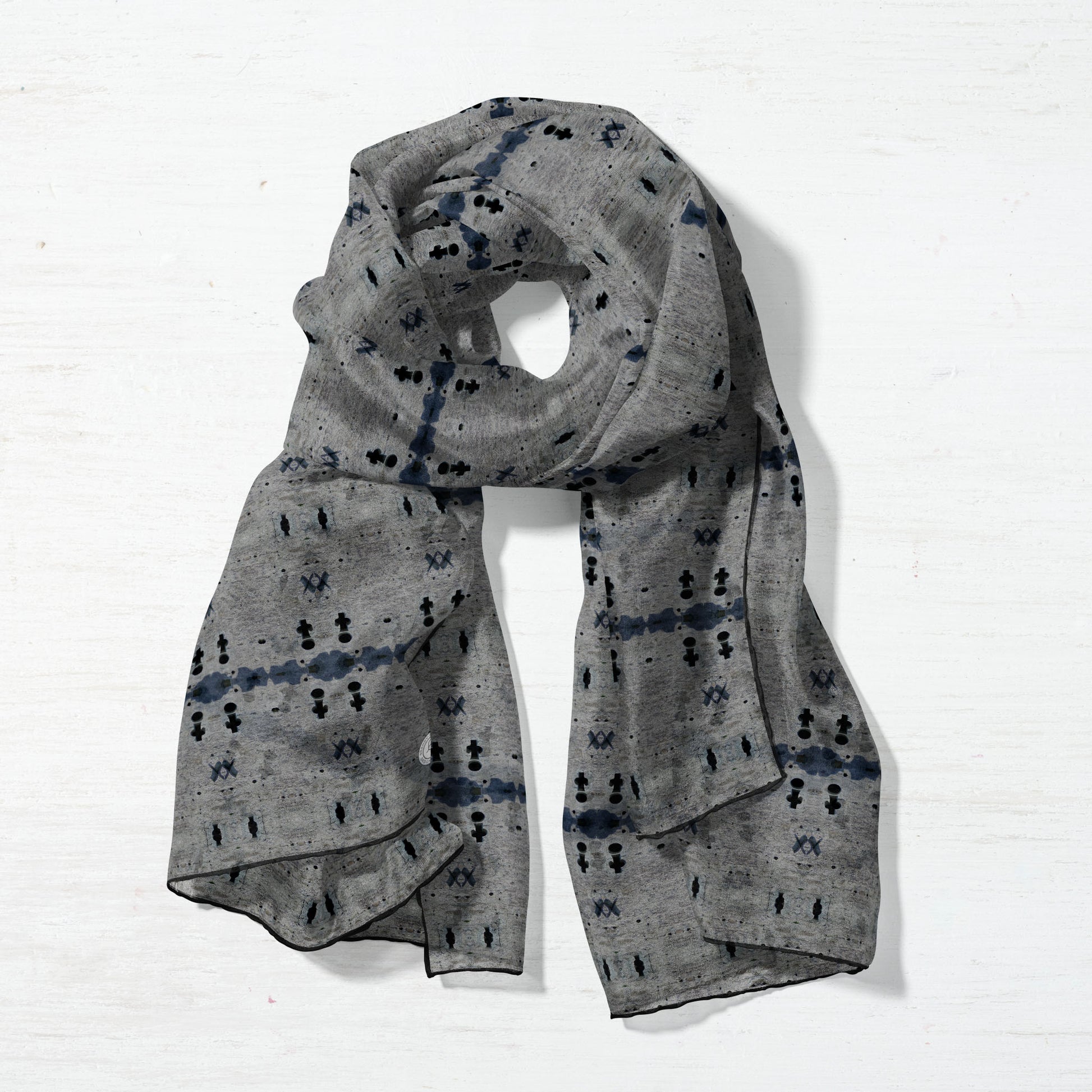 Silk scarf featuring a gray abstract pattern and wrapped in a circle
