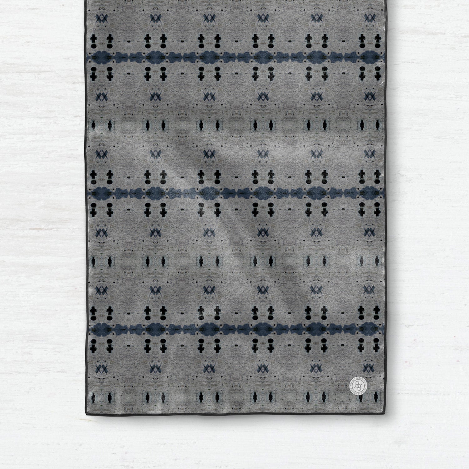 Detail of a silk scarf featuring a gray abstract pattern