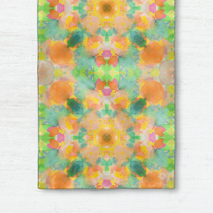 Silk scarf featuring an abstract peach and green hand-painted pattern