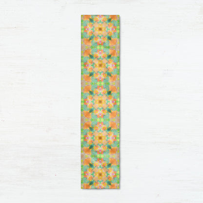 Silk scarf featuring an abstract peach and green hand-painted pattern