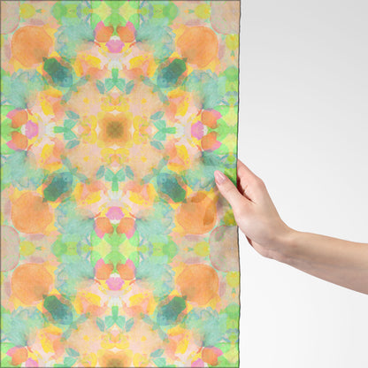 Silk scarf featuring an abstract peach and green hand-painted pattern