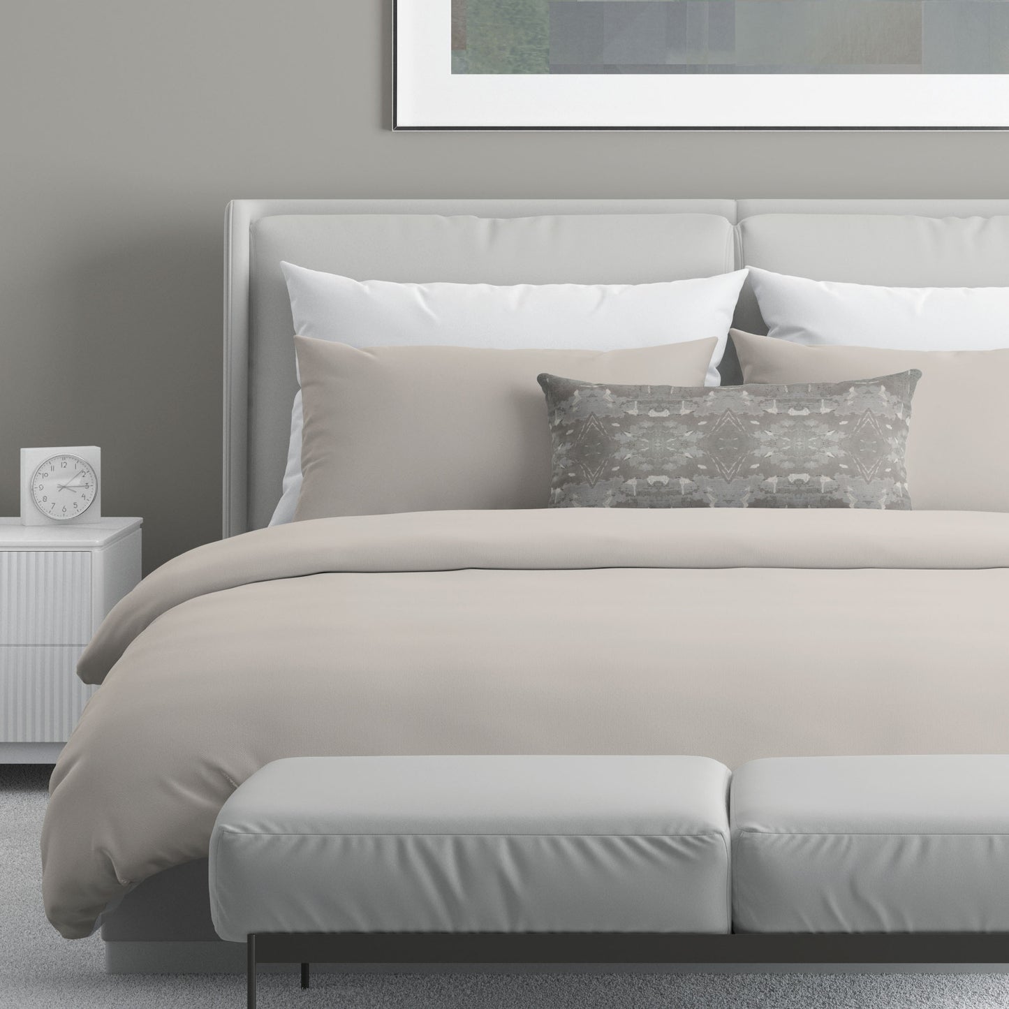 Neutral colored bedroom featuring a bed with an abstract patterned lumbar pillow.