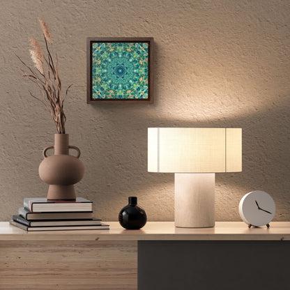 Stretched canvas featuring a teal abstract pattern in a brown float frame hanging over a desk with a vase and lamp