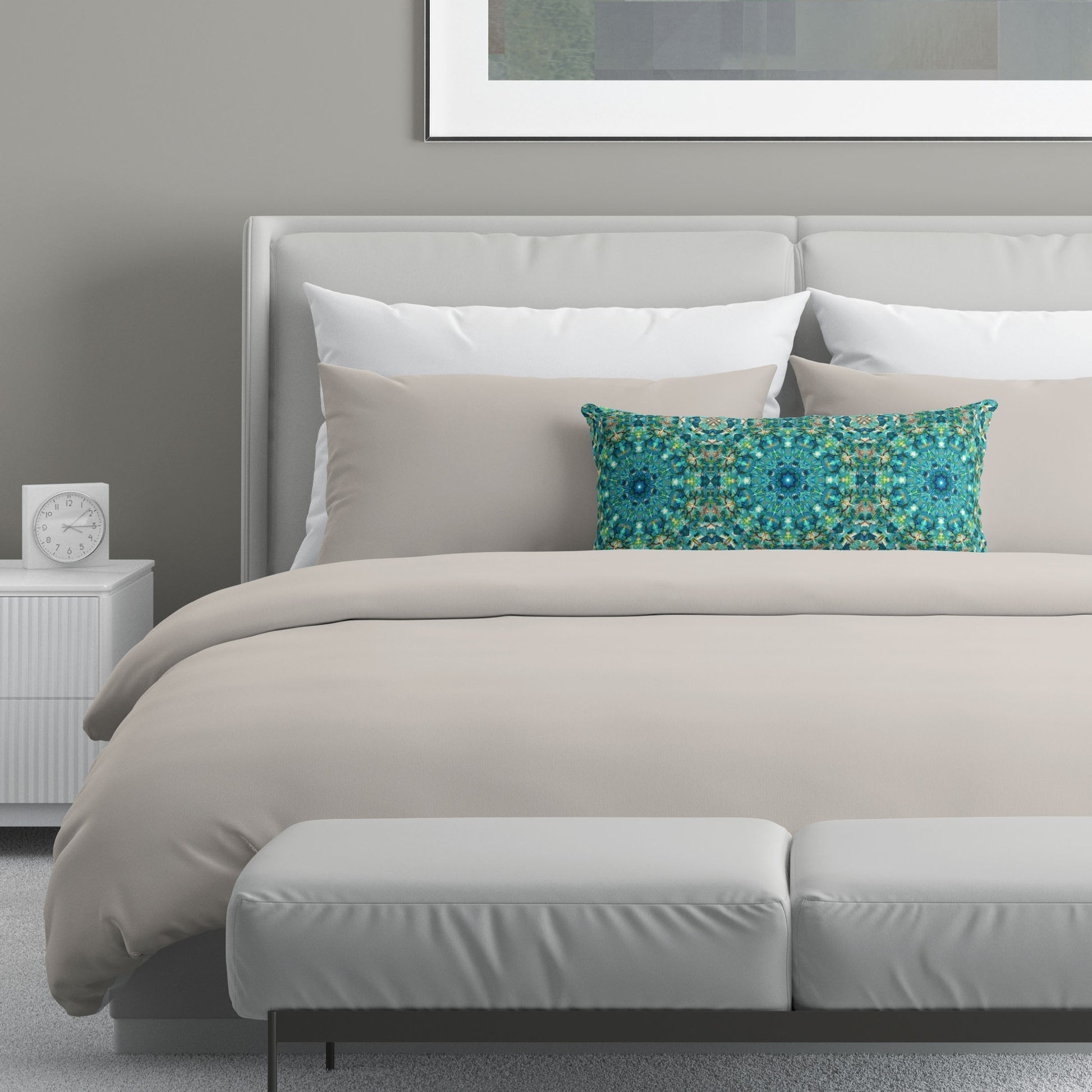 Neutral colored bedroom featuring a bed with a teal abstract patterned lumbar pillow.