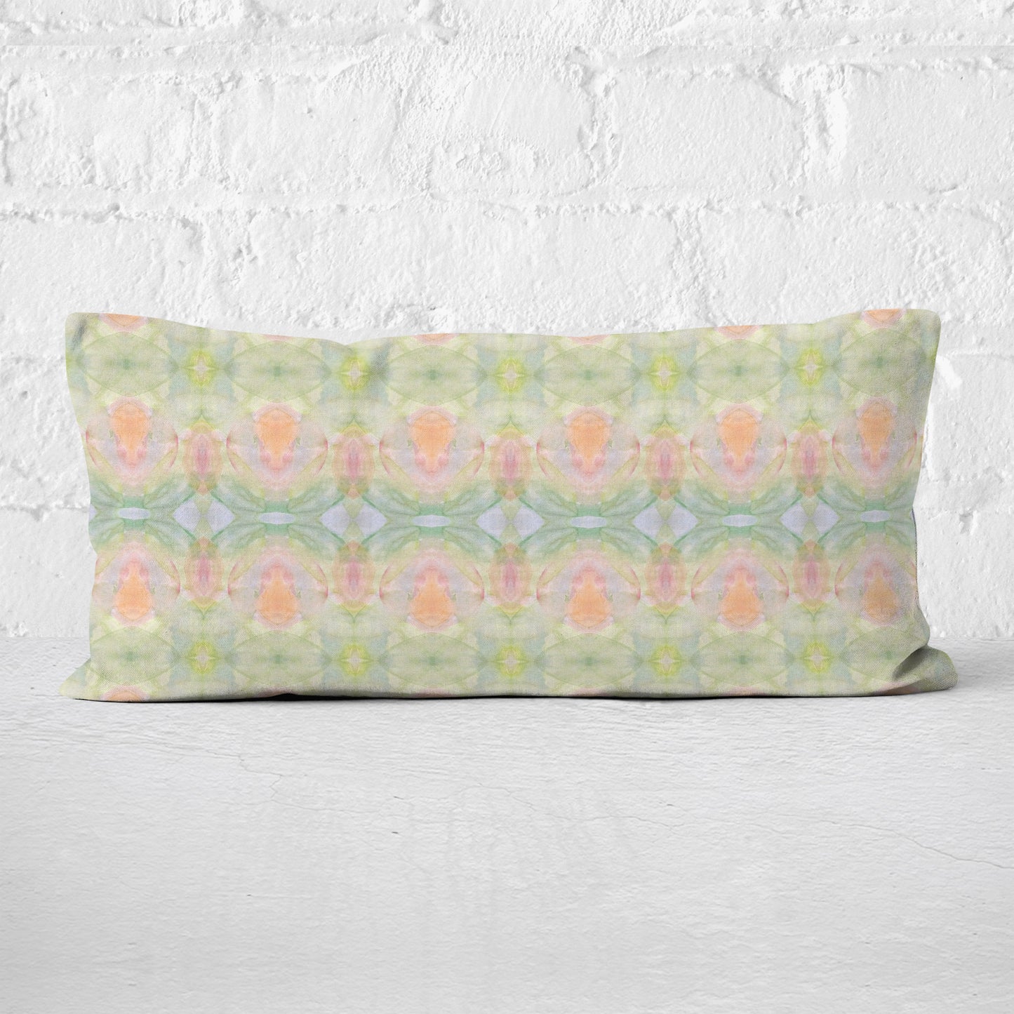Detail of lumbar pillow featuring a hand-painted abstract pattern in pastel colors.