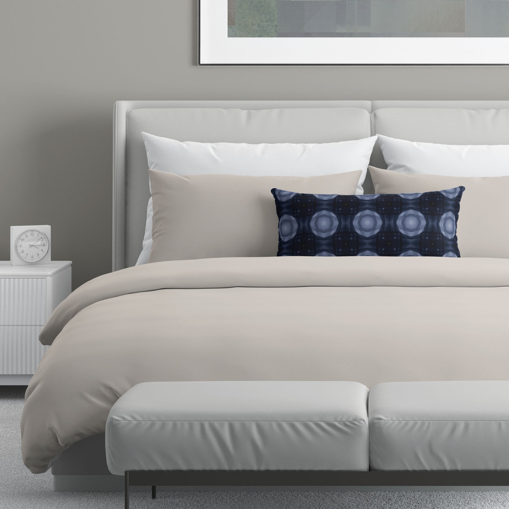 Neutral colored bedroom featuring a bed with a  navy blue abstract patterned lumbar pillow.
