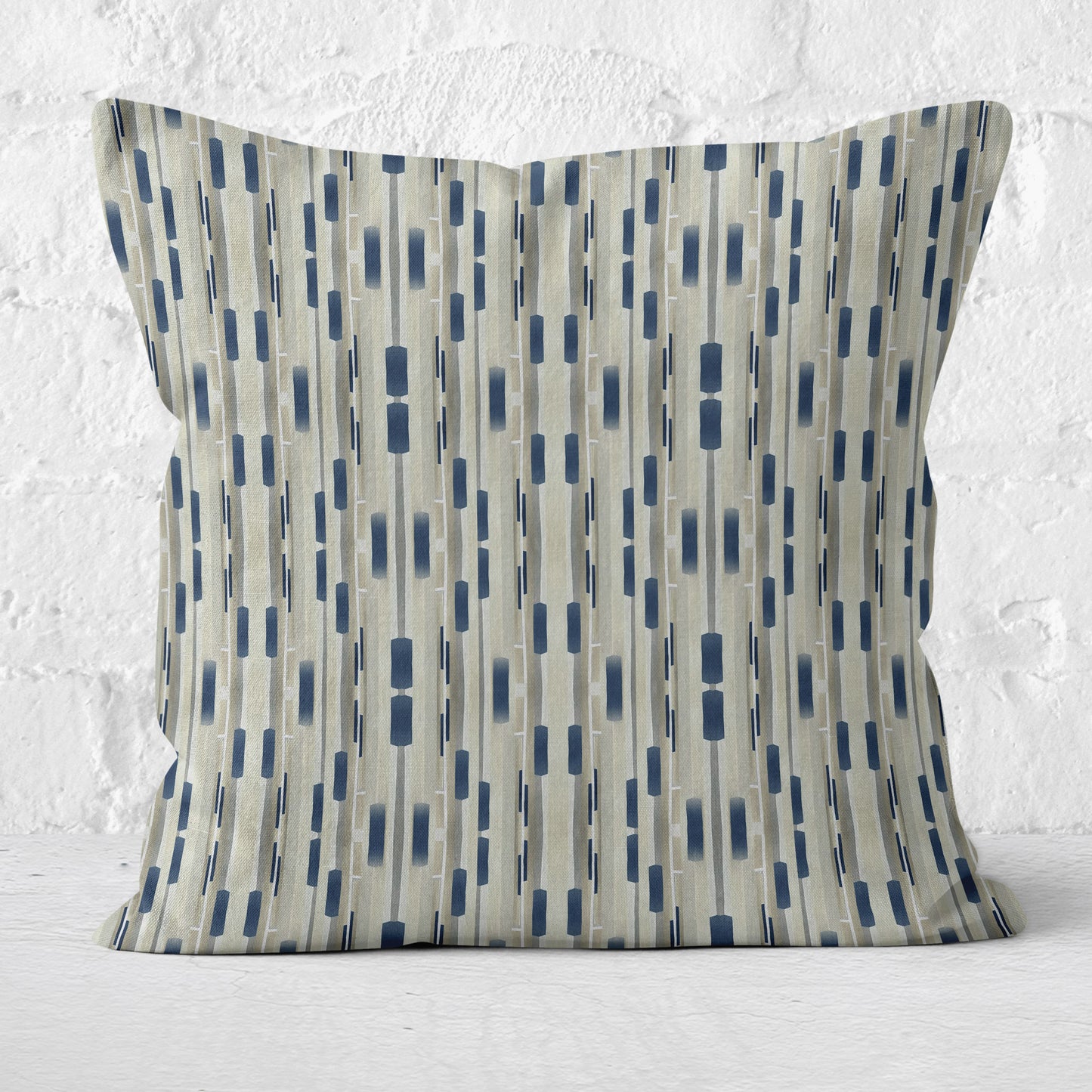 Square throw pillow featuring a tan and navy blue abstract stripe pattern