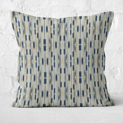 Square throw pillow featuring a tan and navy blue abstract stripe pattern