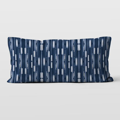 Rectangular lumbar pillow featuring a collaged stripe pattern in blue and white.