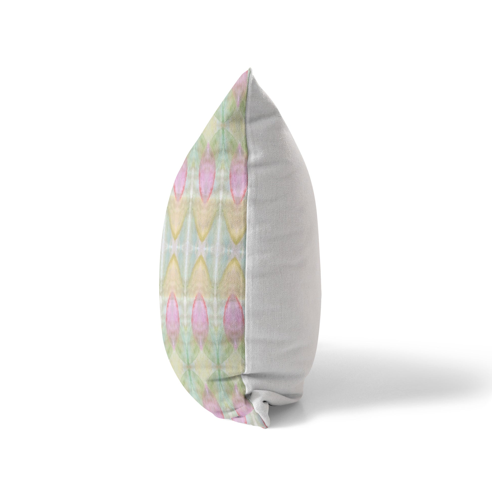Side view of a pillow featuring an abstract multicolor pastel pattern and a solid white back