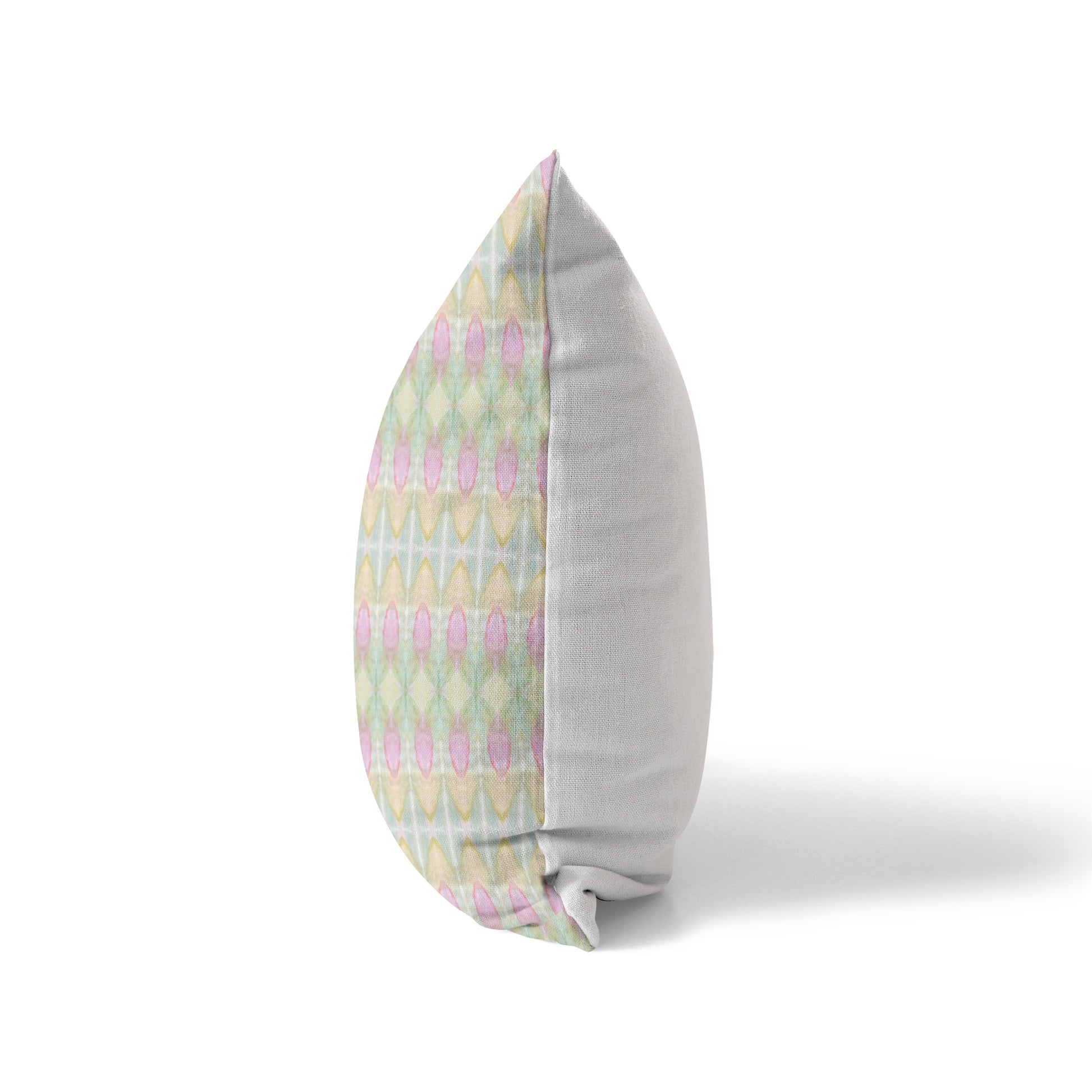 Side view of a pillow featuring a pastel multicolored front and solid white back