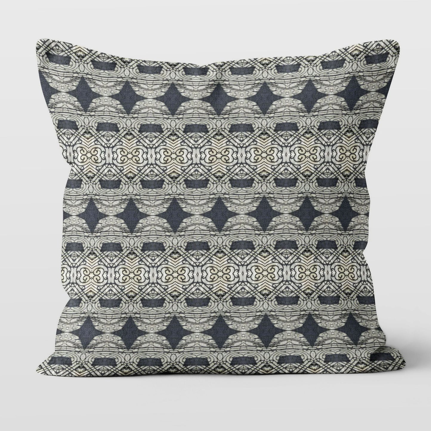Square throw pillow featuring an abstract and ornate pattern in black and grey tones.
