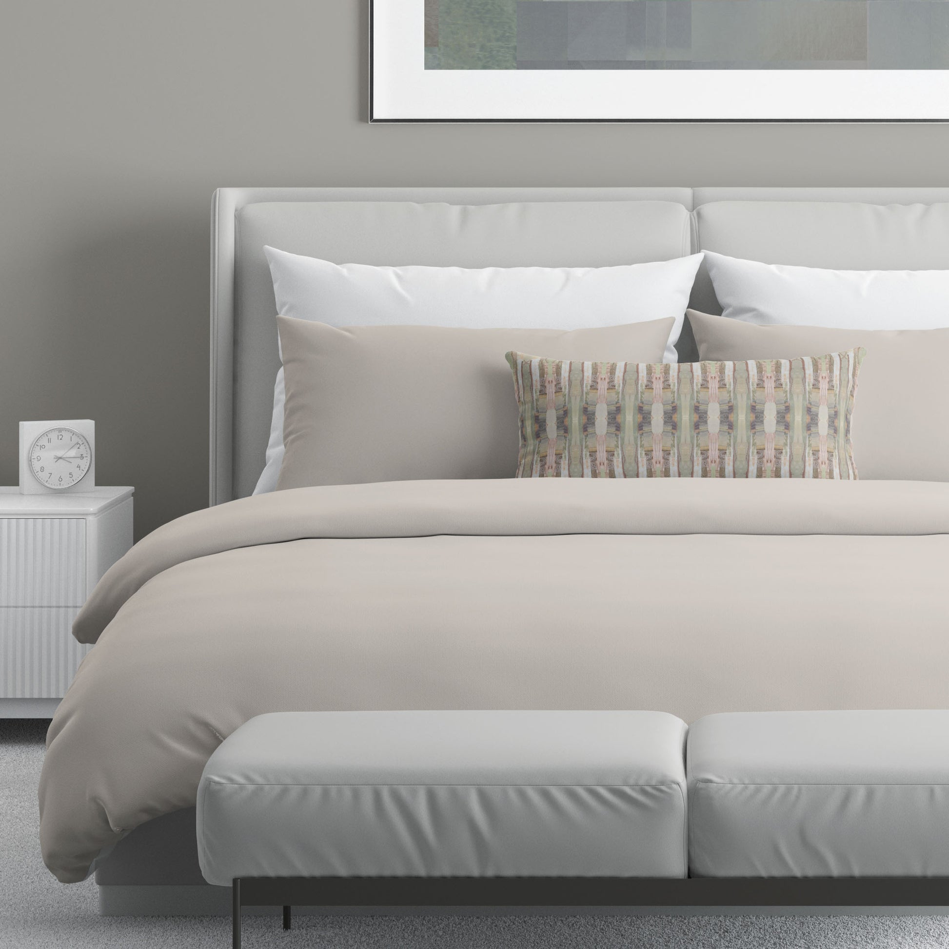 Neutral bedroom featuring a 12 x 24 pillow with a pink, green, and beige cut paper collage pattern