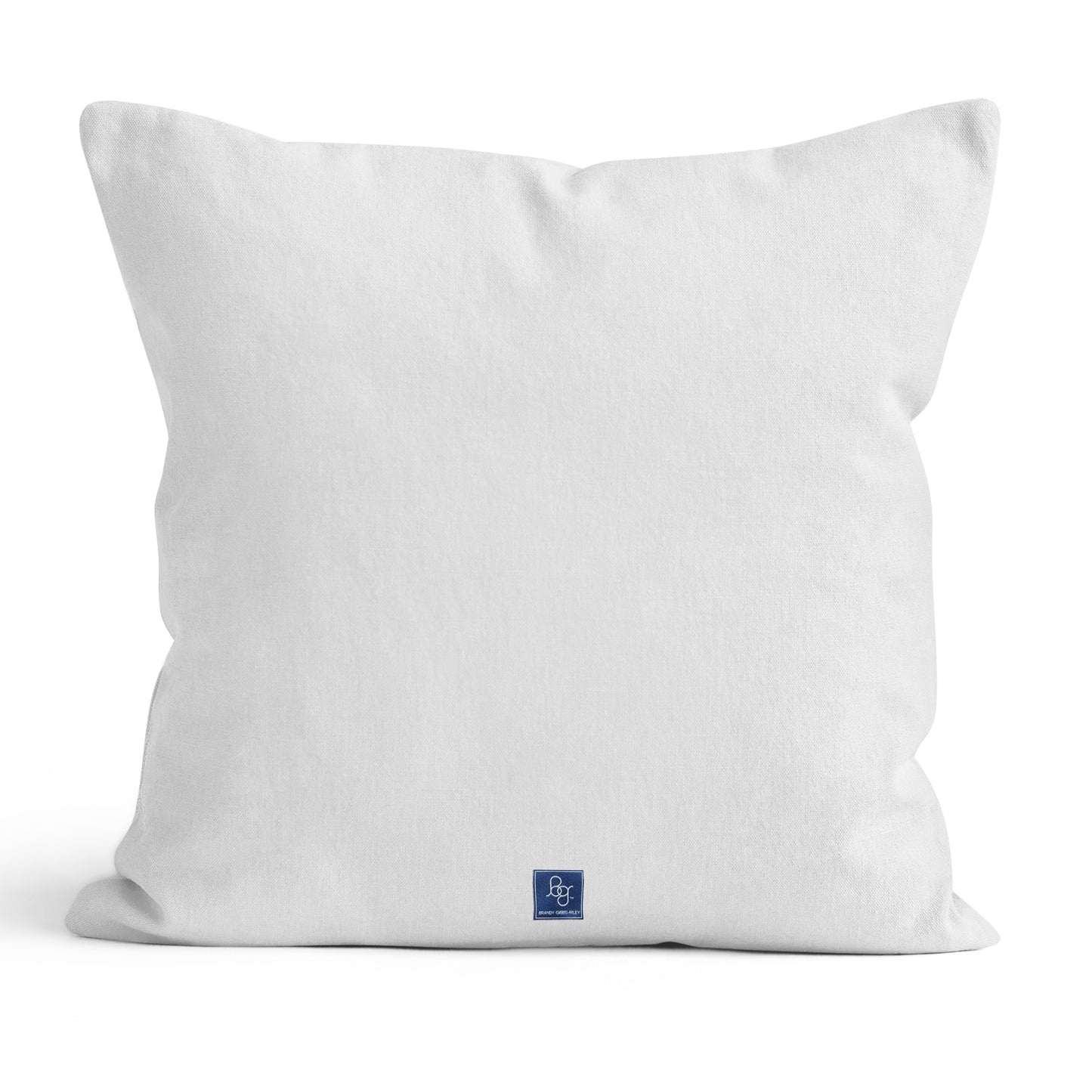 Solid white back of pillow with navy blue square label