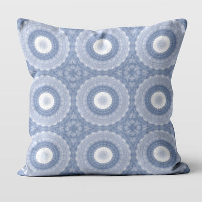 Square throw pillow featuring a periwinkle blue, purple, and white abstract circular pattern