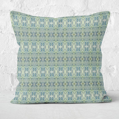 Cotton canvas throw pillow featuring an abstract blue and green pattern on white brick background.