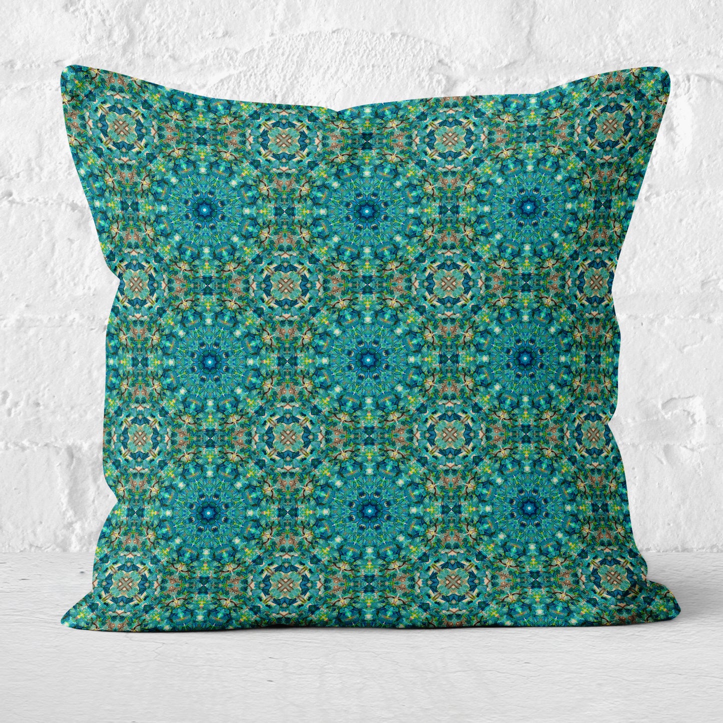 Pillow featuring an abstract teal watercolor pattern on white brick background