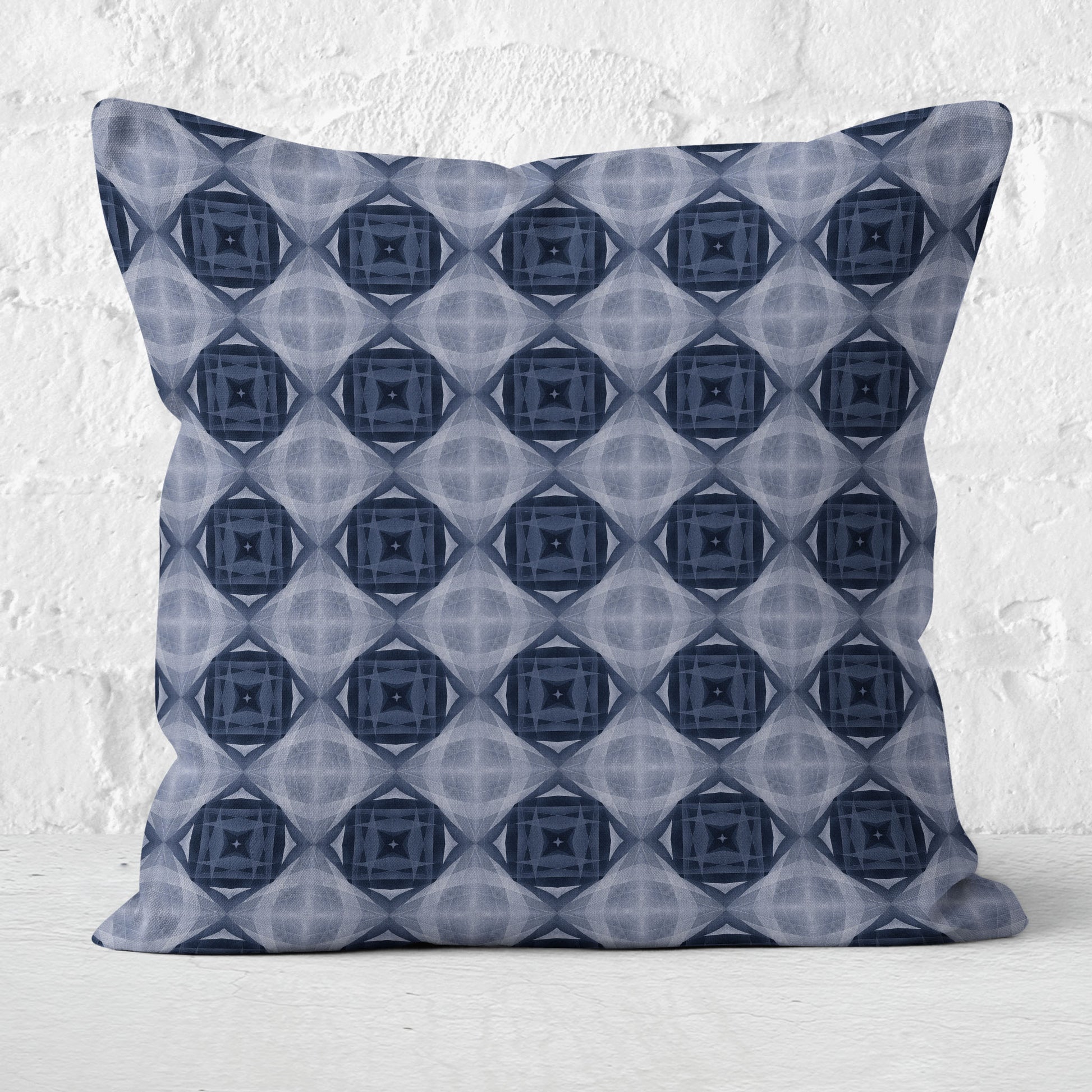 Pillow featuring a blue collage pattern on a white brick background