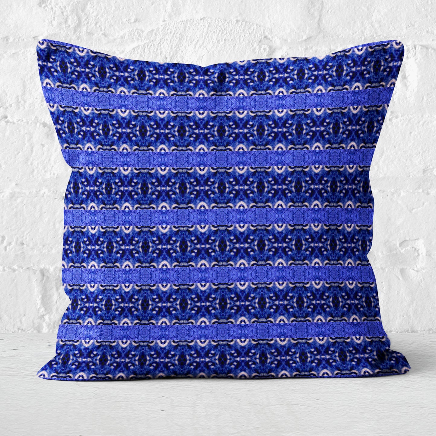 Cobalt blue striped pillow on brick background