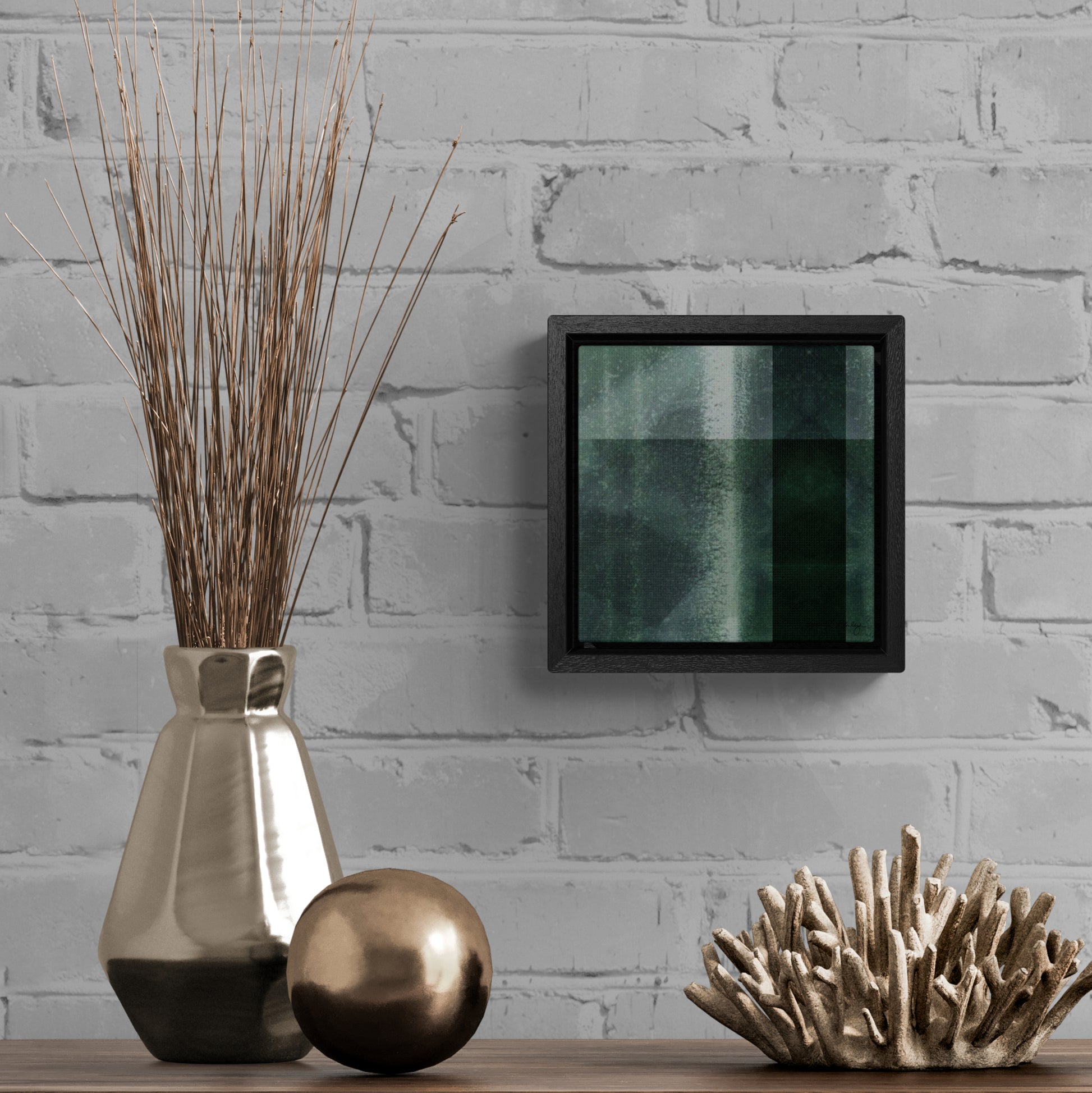 Small framed gallery wrapped canvas featuring a green shibori tartan style  pattern, hanging above small sculptures