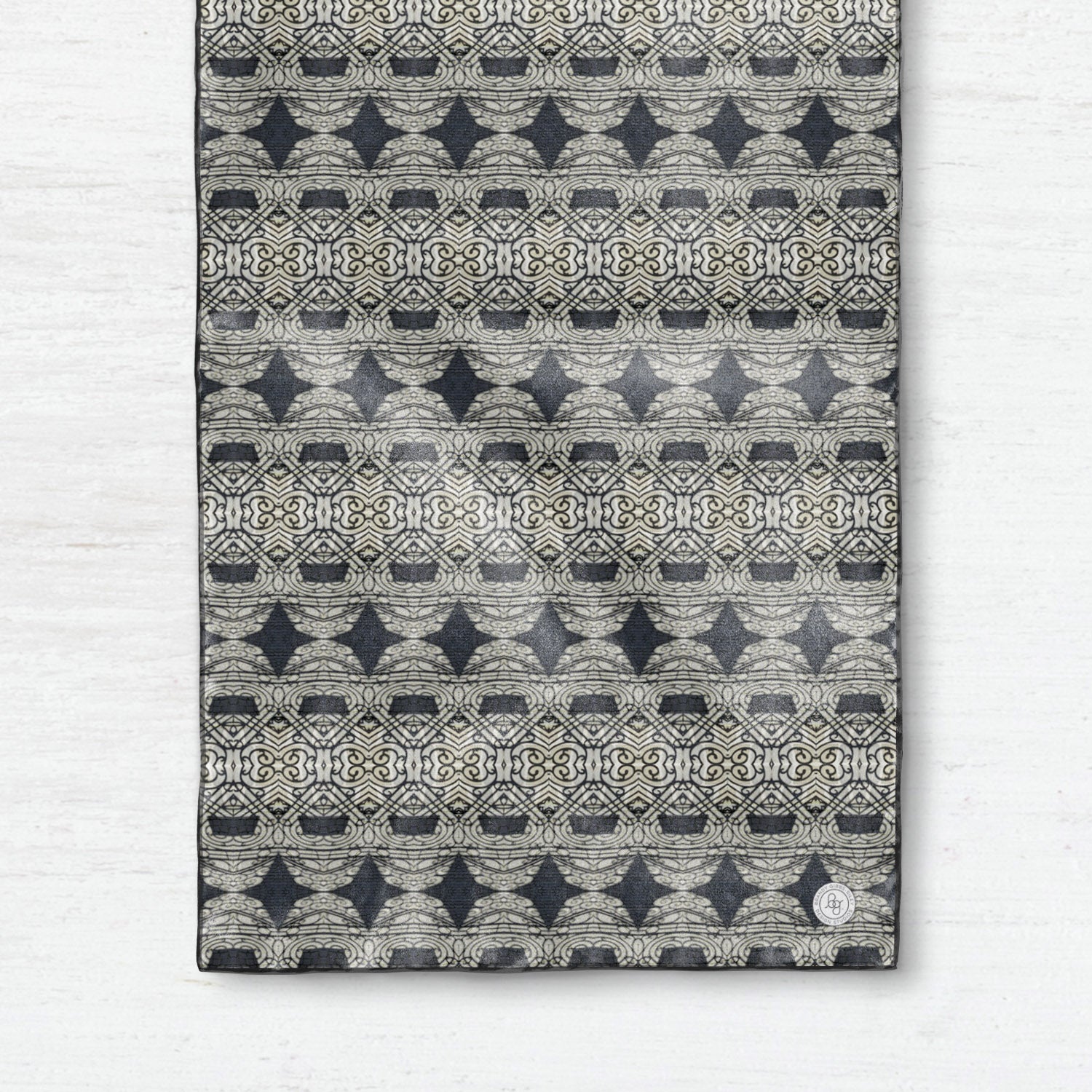 Oblong silk scarf featuring a charcoal gray abstract pattern,