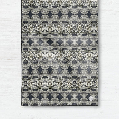 Oblong silk scarf featuring a charcoal gray abstract pattern,