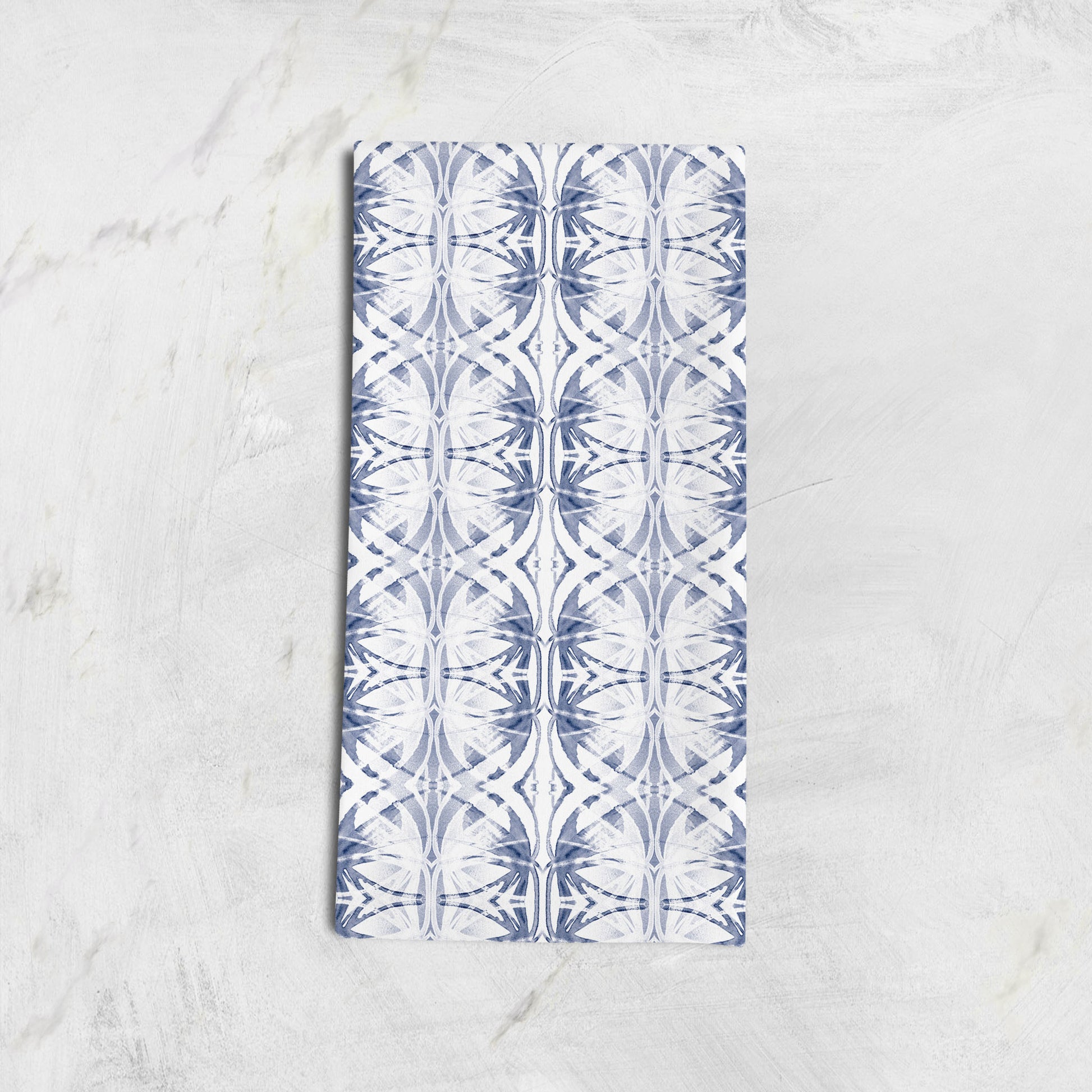 Folded cotton hemp tea towel featuring a blue and white abstract pattern 