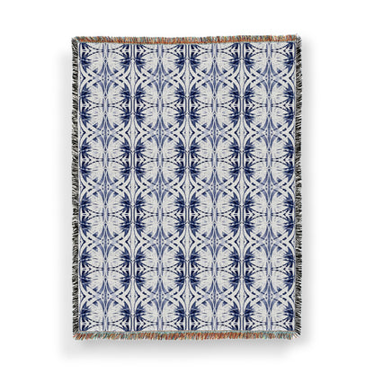 Woven throw blanket featuring an abstract blue and white pattern