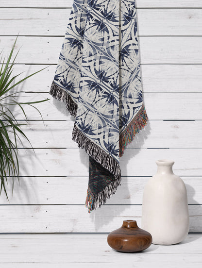 Woven throw blanket featuring an abstract blue and white pattern