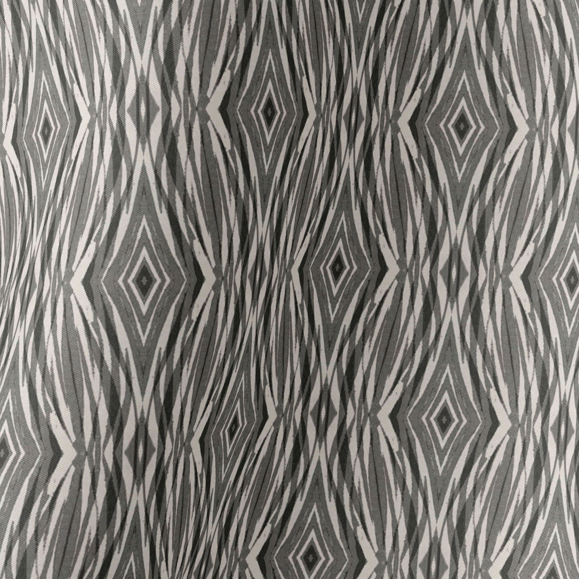 Image detail of a silk scarf featuring a linocut pattern in beige, gray, and black.