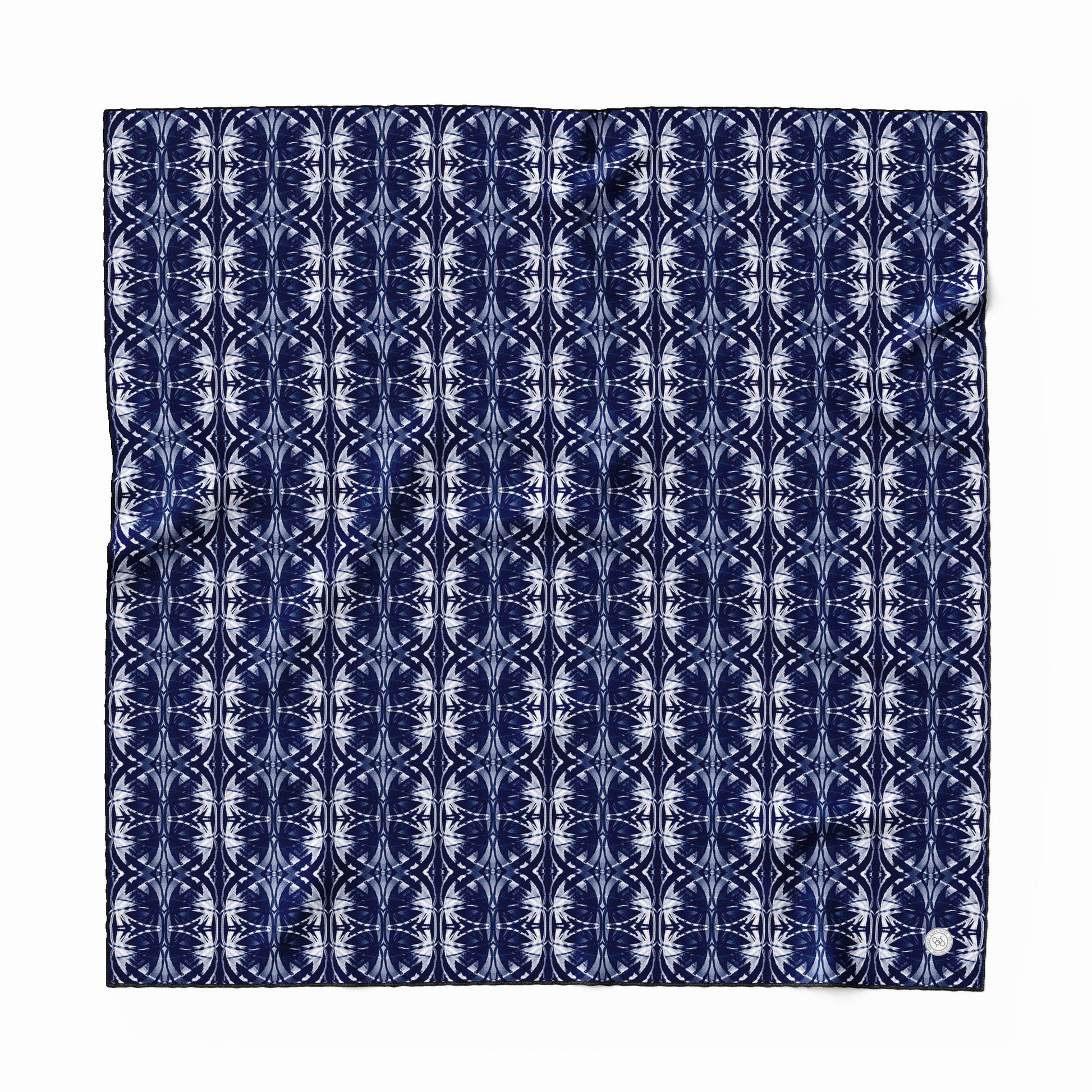 Silk scarf featuring a navy blue and white hand-painted pattern.