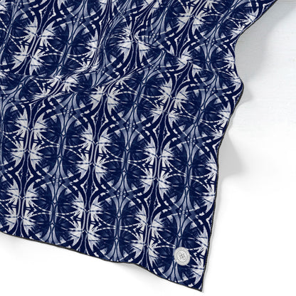 Silk scarf featuring a navy blue and white hand-painted pattern.