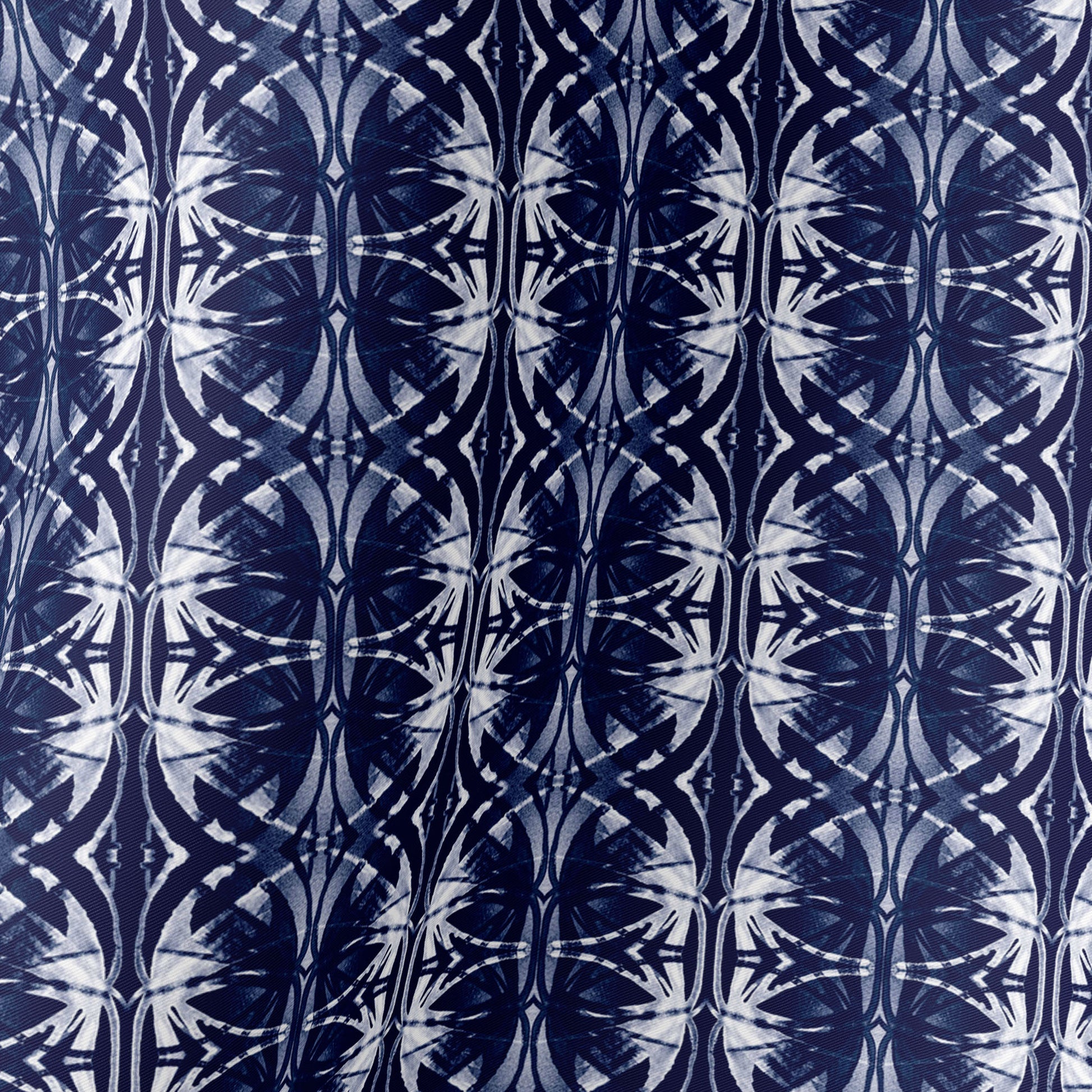 Detail of silk scarf featuring a navy blue and white hand-painted pattern.